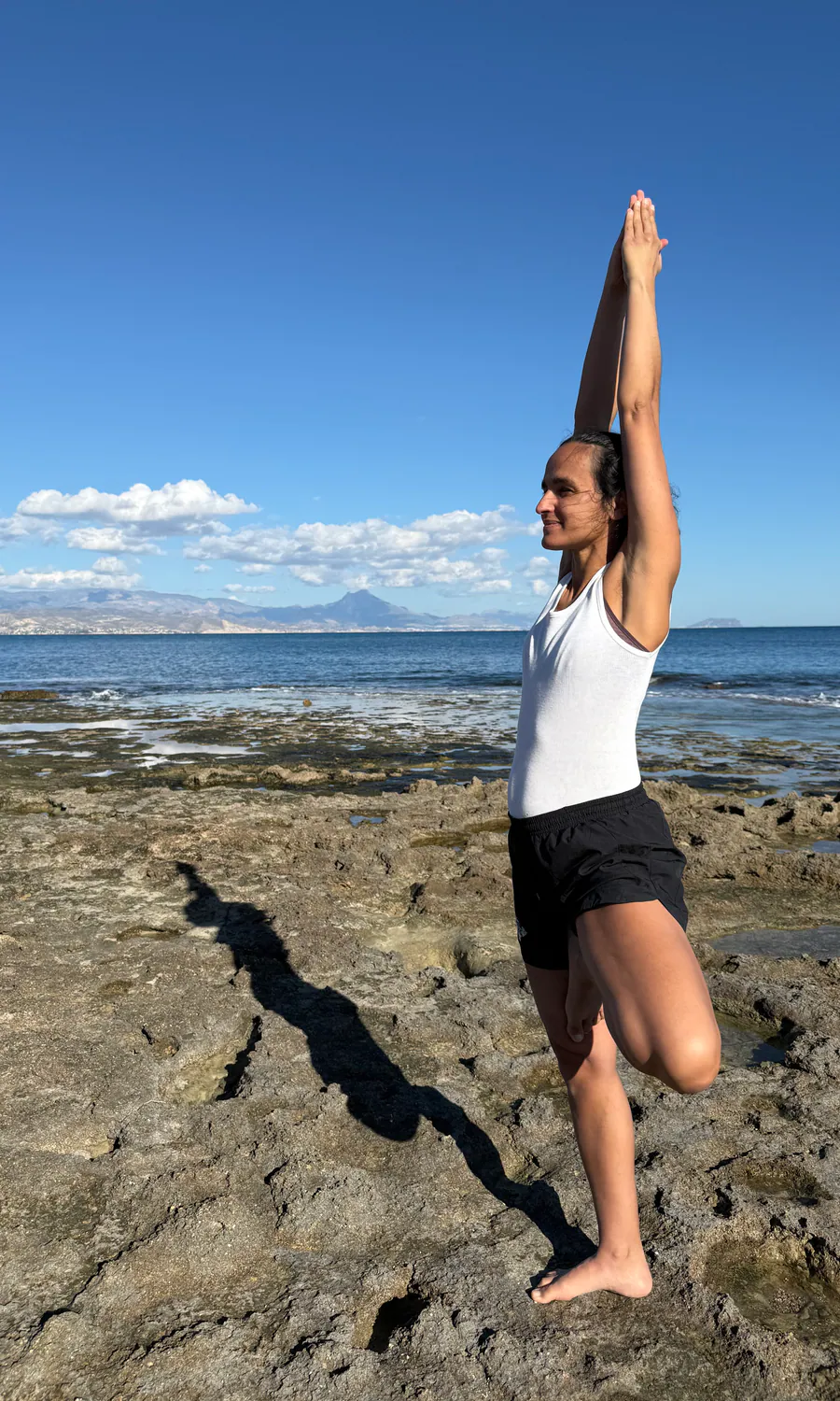 Susana practising a standing balance by the sea