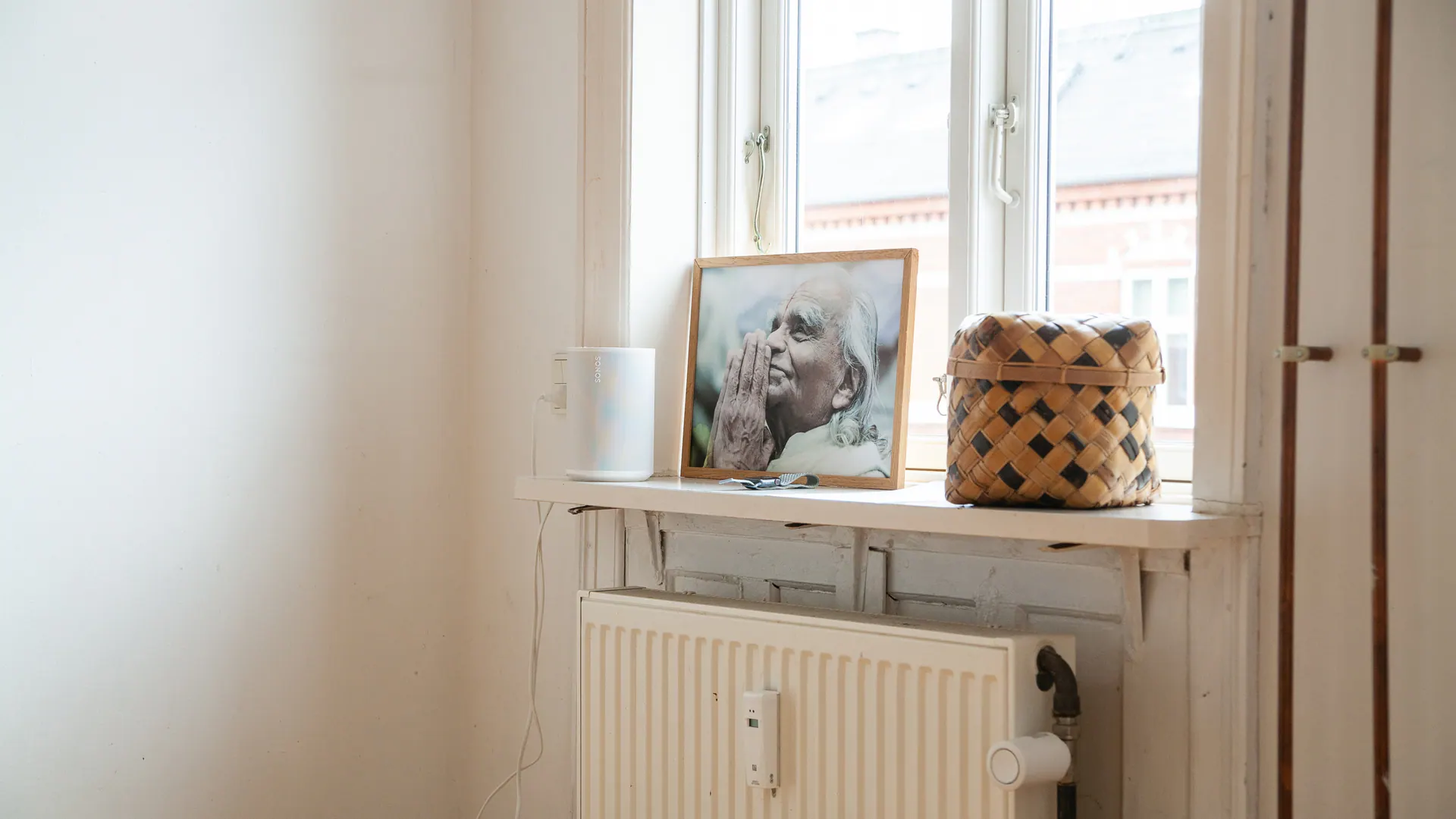 A framed portrait of B.K.S. Iyengar in the yoga studio window